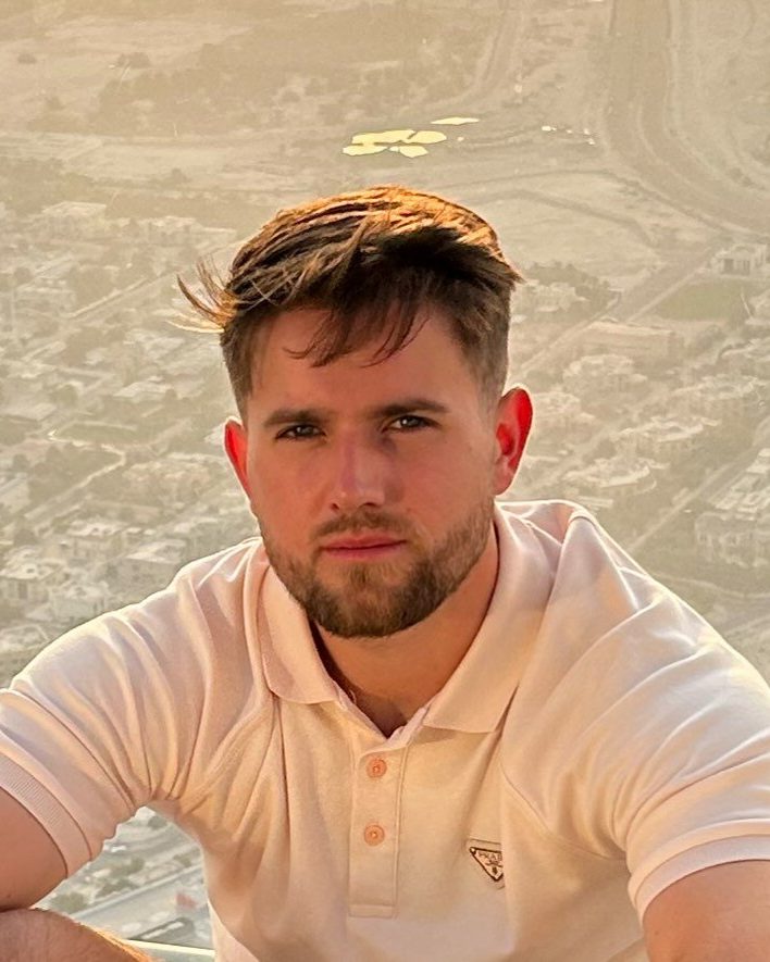 Conor Chapman, founder of Mango Digital, in a pale polo shirt against a sunlit city view